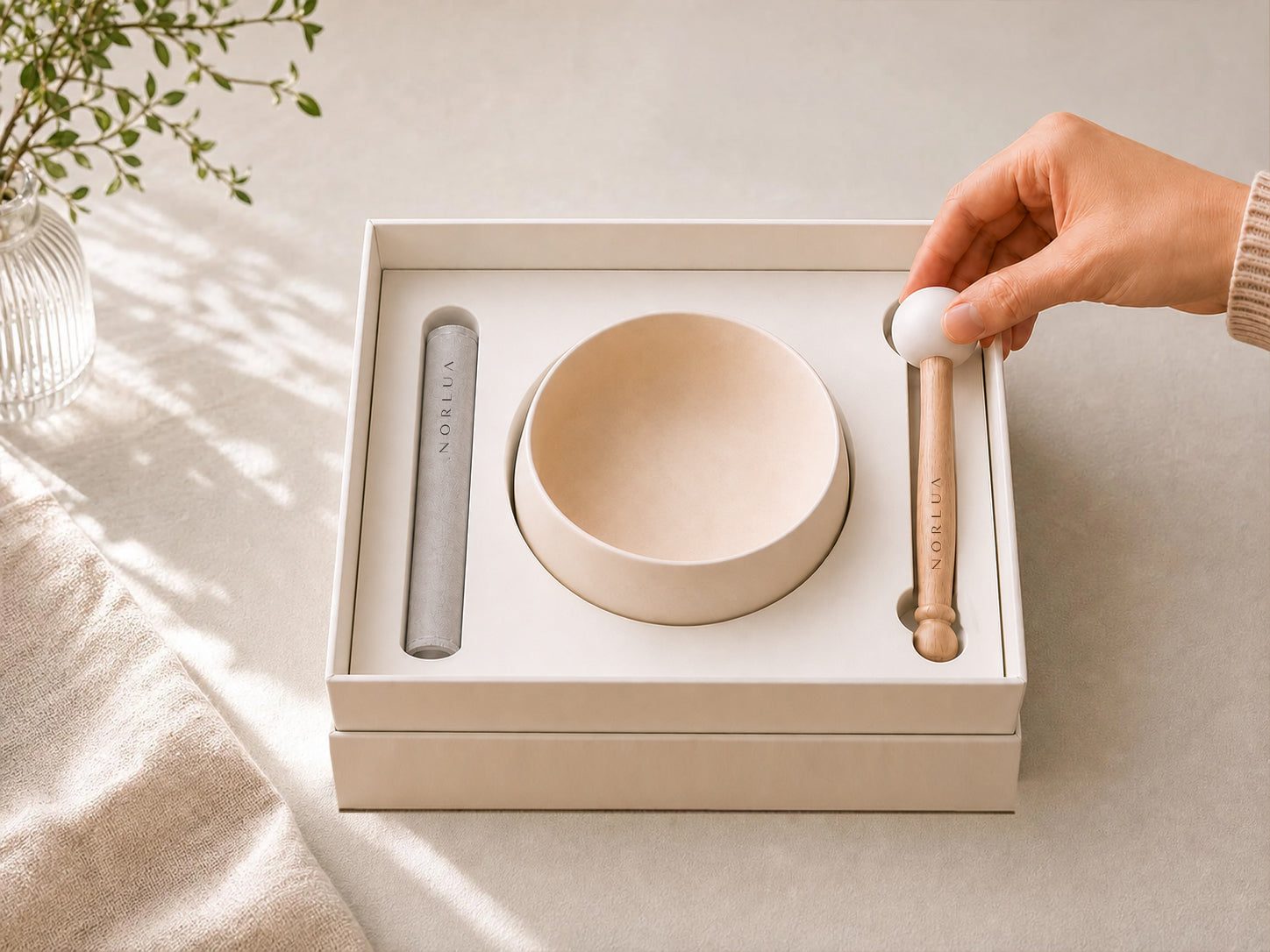 NORLUA singing bowl, playing stick and wooden mallet arranged inside the presentation box
