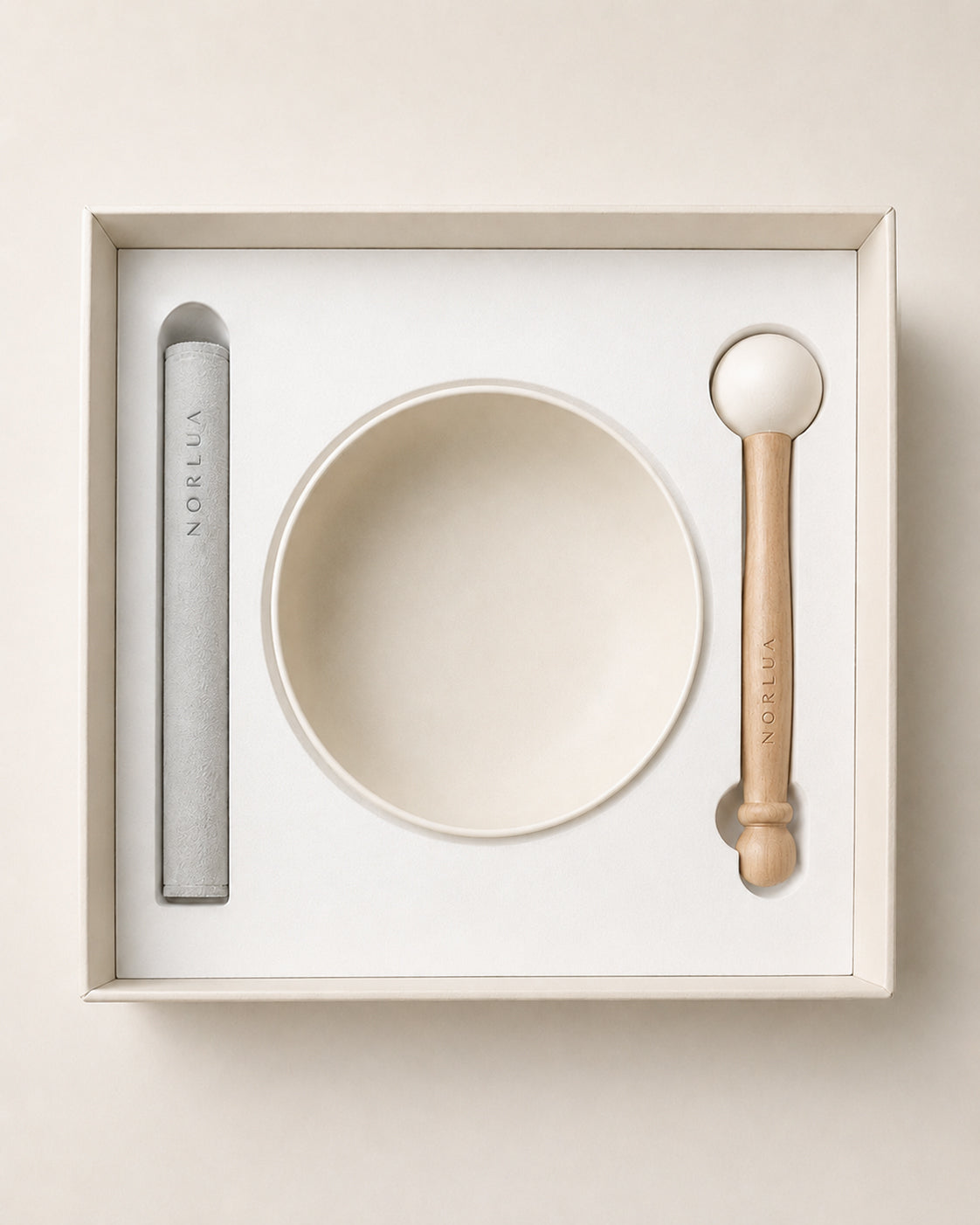 Top view of the NORLUA singing bowl set arranged inside its protective gift packaging