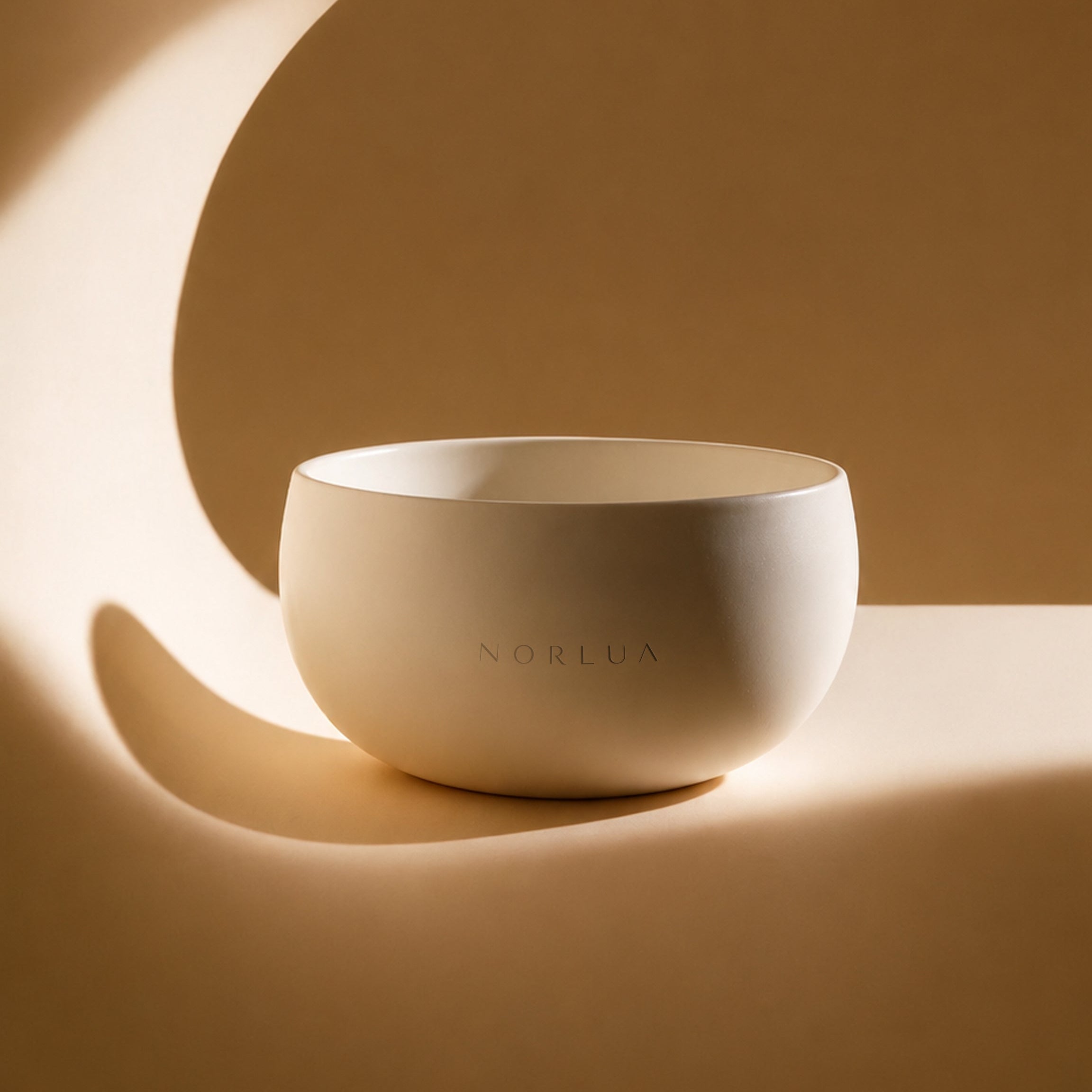 NORLUA Warm Ivory singing bowl in sculptural warm light