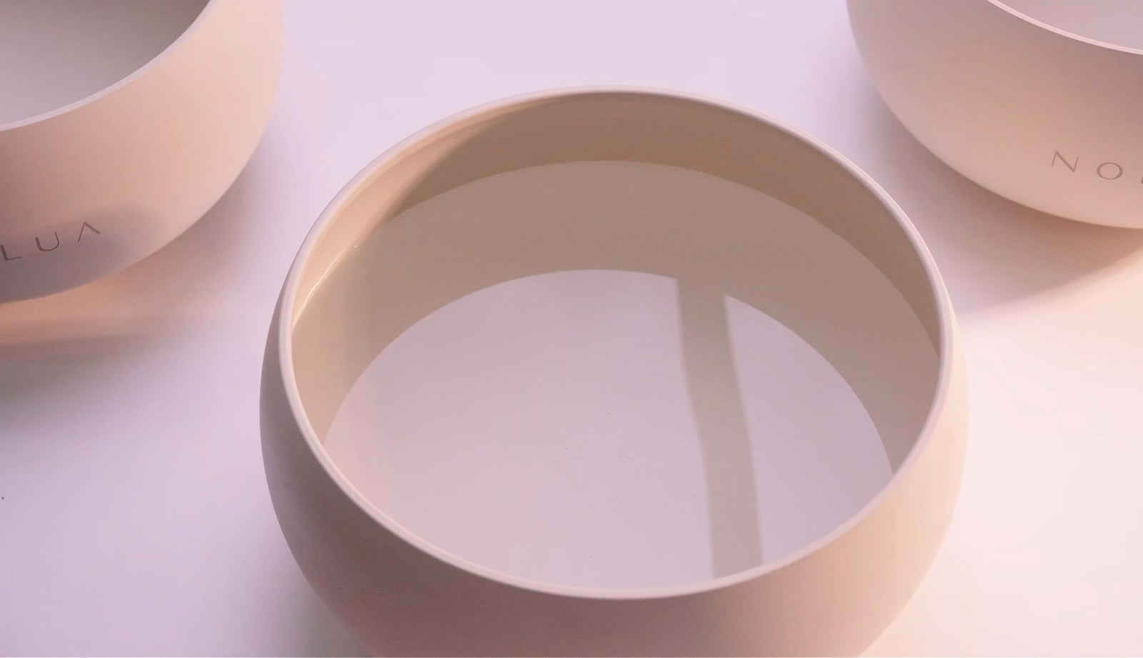 Close-up of the NORLUA Warm Ivory singing bowl in soft natural light